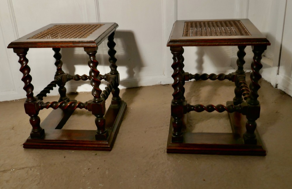 A Pair of Oak Barley-twist and Bergère Fireside Stools