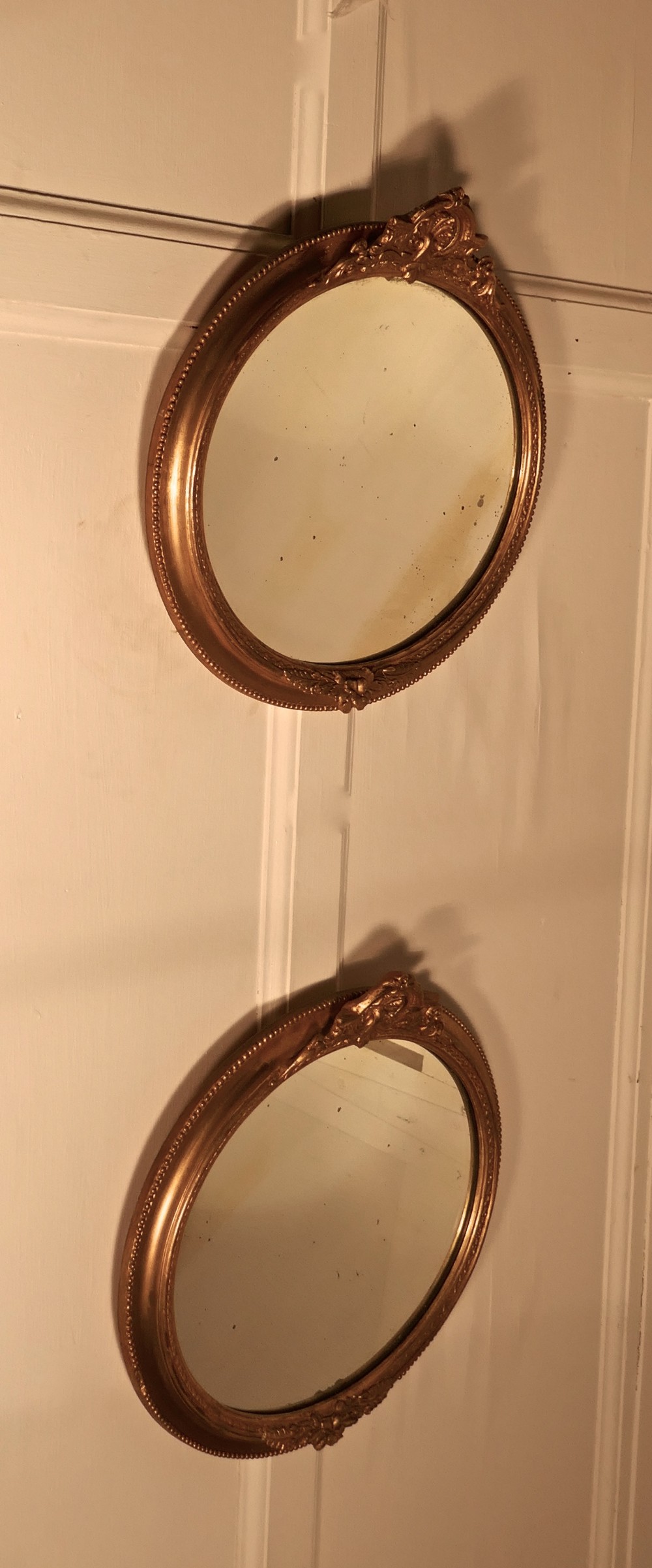 A Rare Pair of 19th Century Regency Style Oval Gilt Mirrors