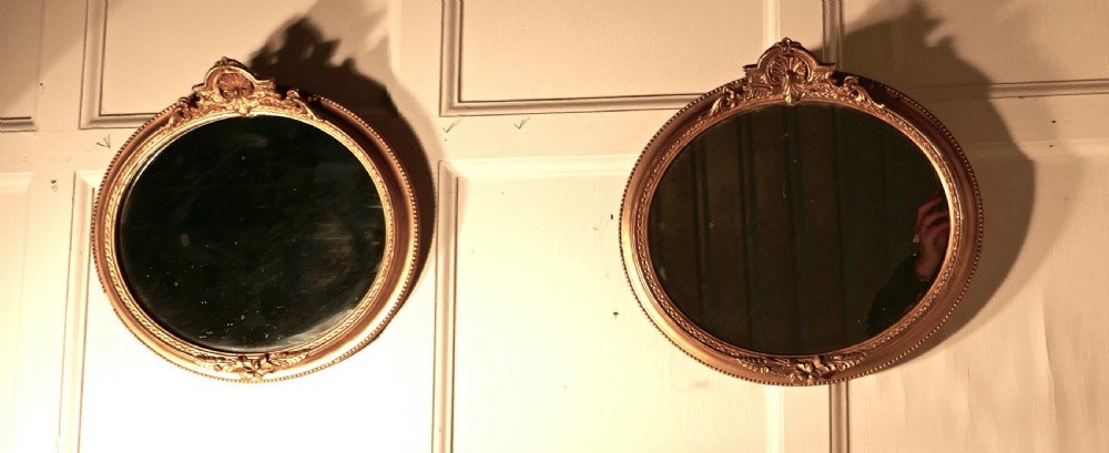 A Rare Pair of 19th Century Regency Style Oval Gilt Mirrors View II
