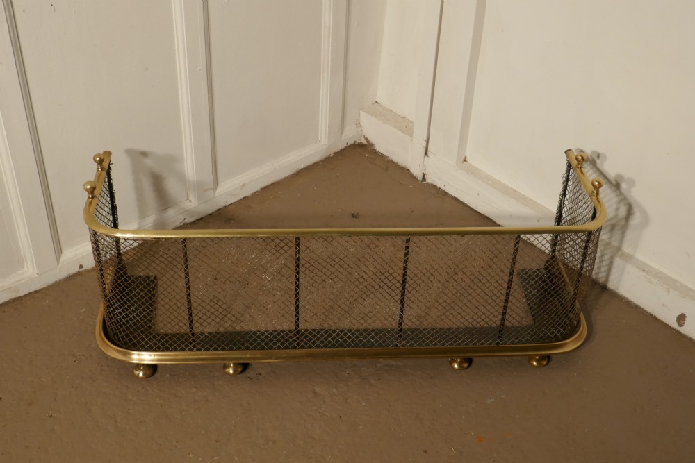 A Victorian Brass and Iron Club Fender