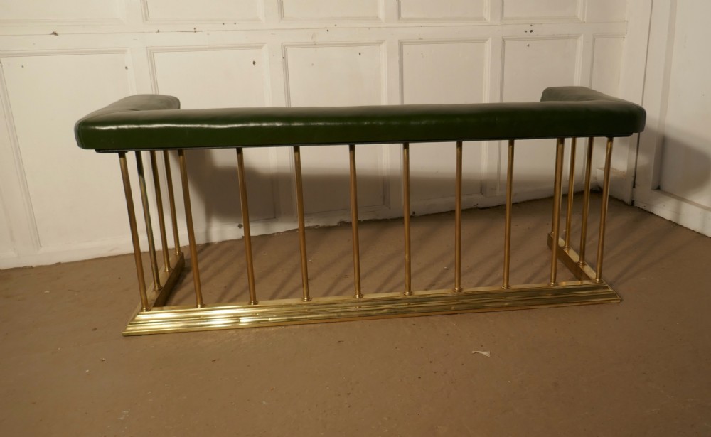 A Large Brass and Green Leather Club Fender