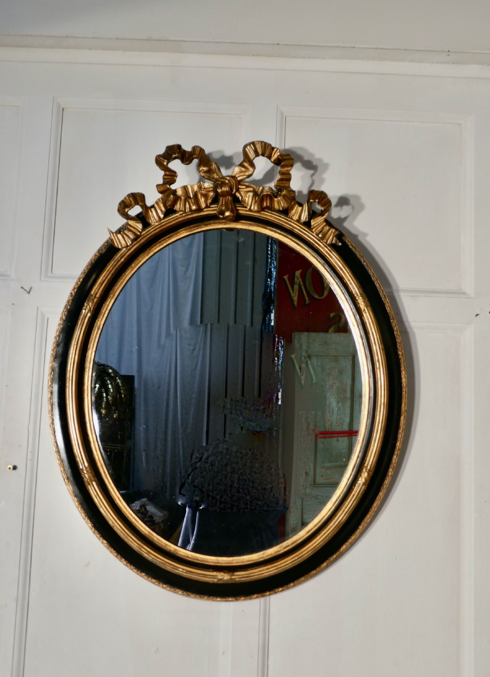 A Large French Ebonised and Gilt Oval Wall Mirror View II