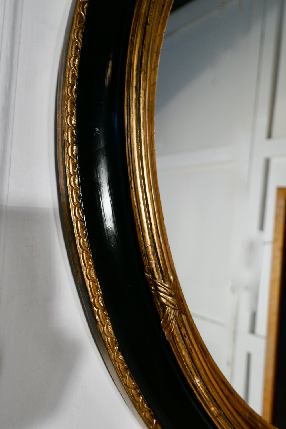 A Large French Ebonised and Gilt Oval Wall Mirror View IV