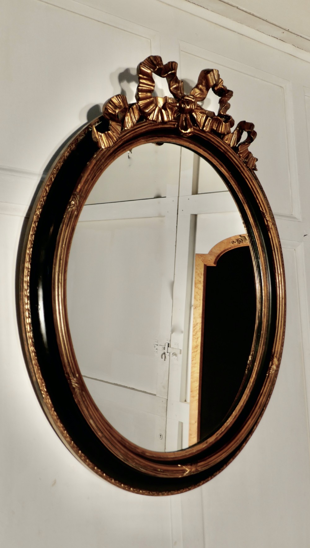 A Large French Ebonised and Gilt Oval Wall Mirror View V