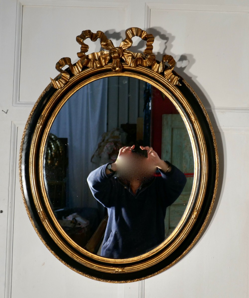 A Large French Ebonised and Gilt Oval Wall Mirror View VI