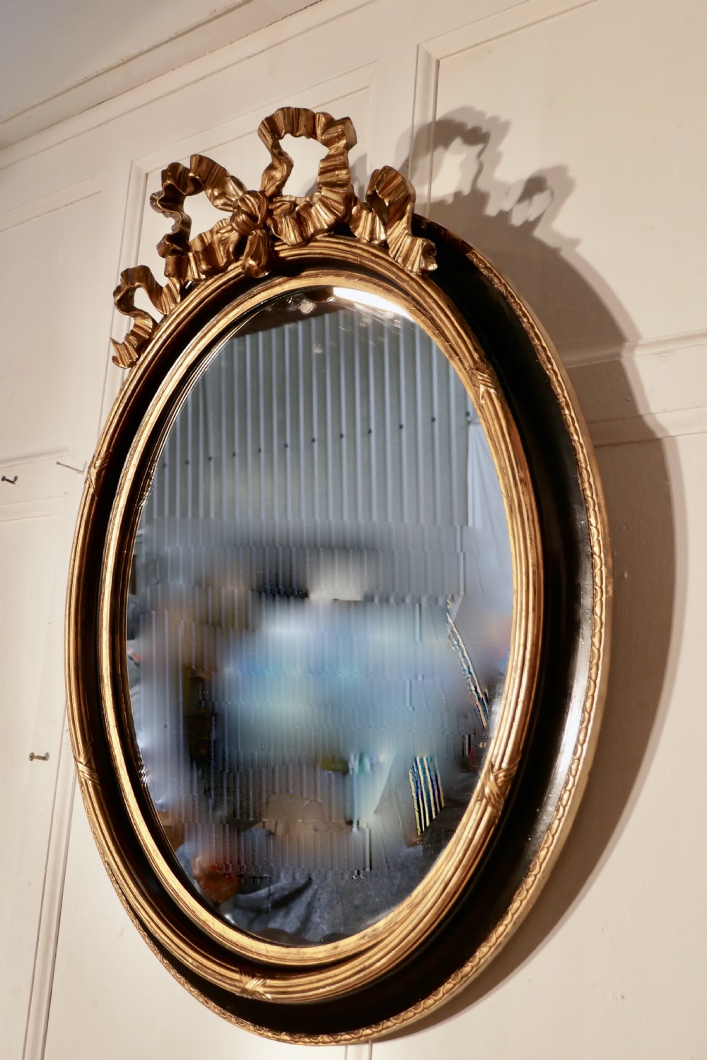 A Large French Ebonised and Gilt Oval Wall Mirror View VII
