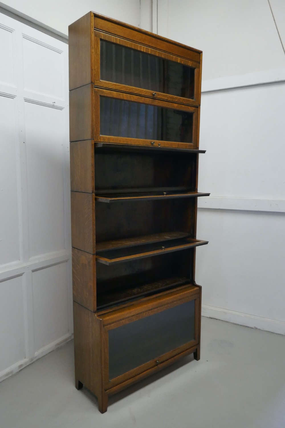 A Tall Art Deco Golden Oak Barrister Waterfall Bookcase, made by Gumm View IV