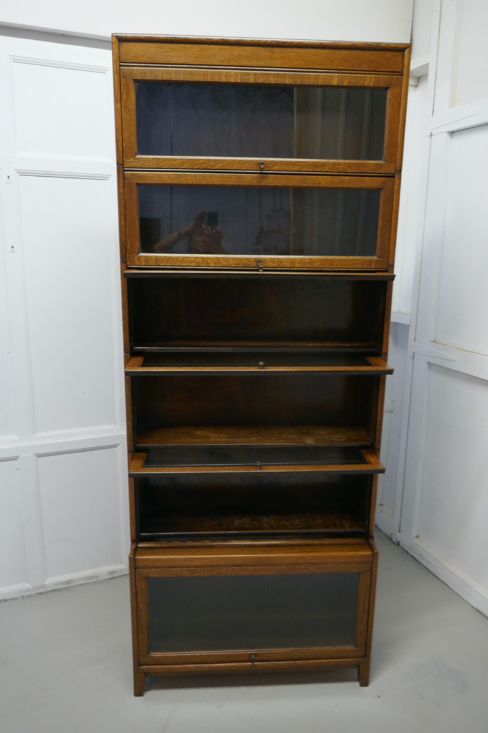 A Tall Art Deco Golden Oak Barrister Waterfall Bookcase, made by Gumm View VI