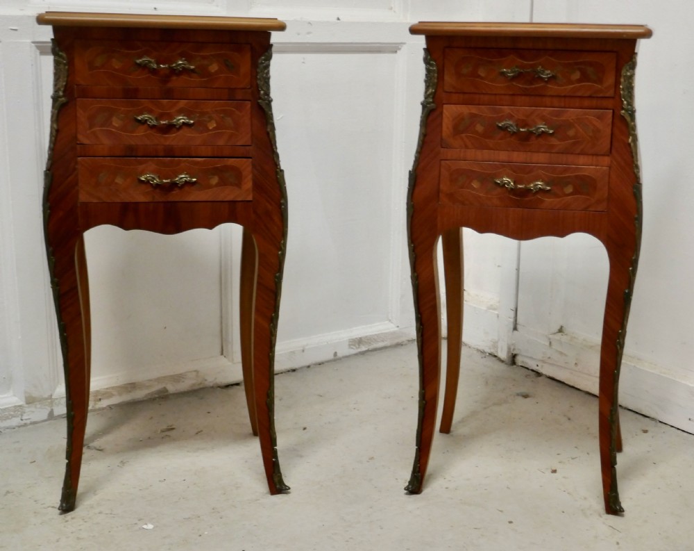 A Pair of Inlaid French Marquetry Bombe Shaped Bedside Cupboards
