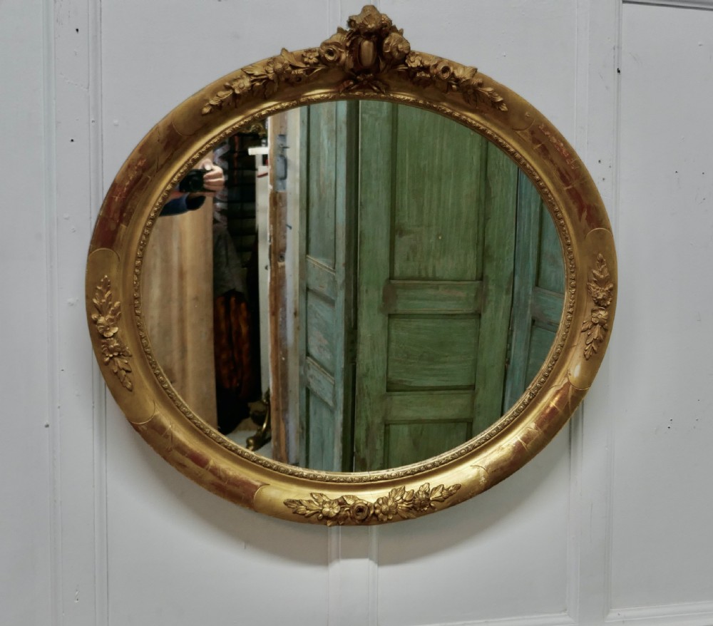 A Large French Rococo Oval Gilt Wall Mirror