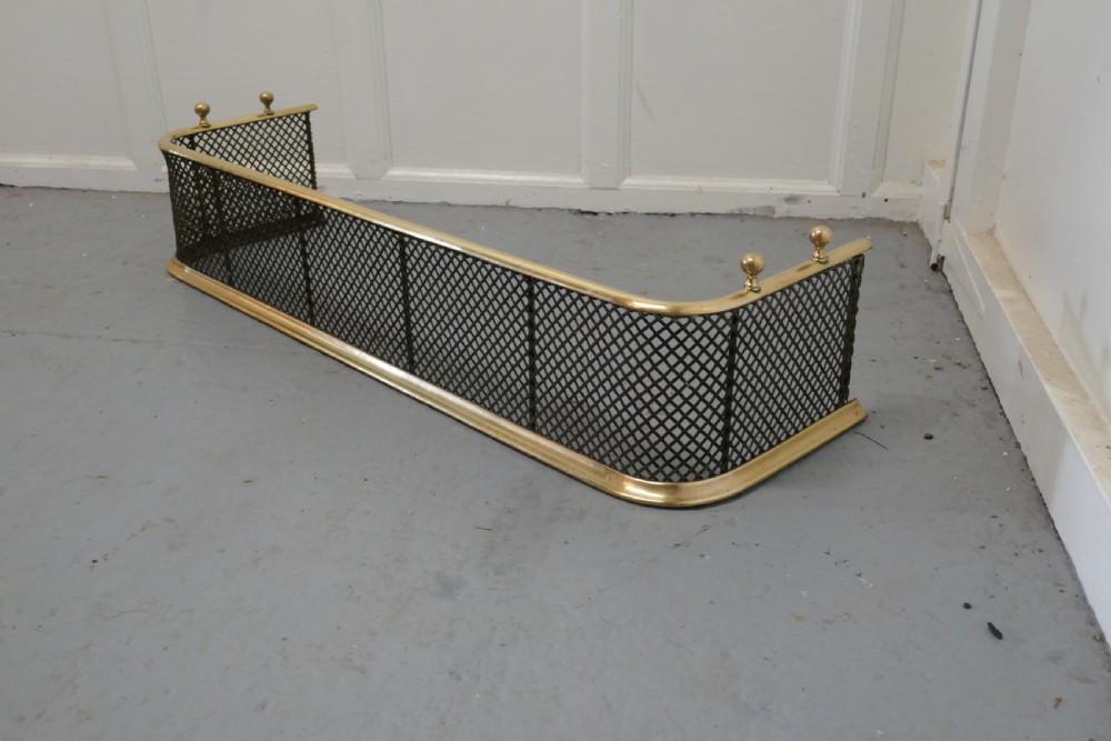 A Victorian Brass and Iron Fender or Fireguard View V