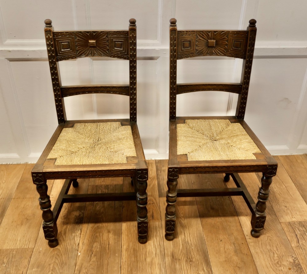 A Pair of Arts and Crafts Gothic Carved Oak Hall Chairs View III