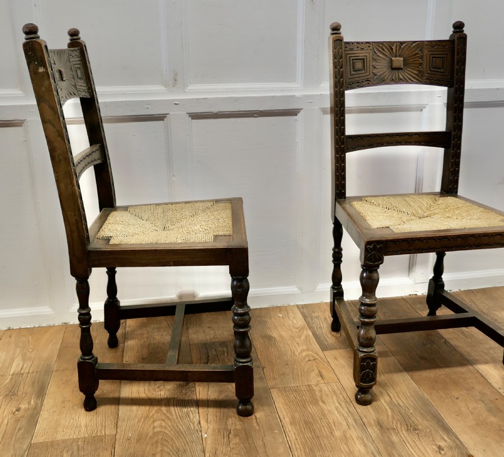A Pair of Arts and Crafts Gothic Carved Oak Hall Chairs View IV