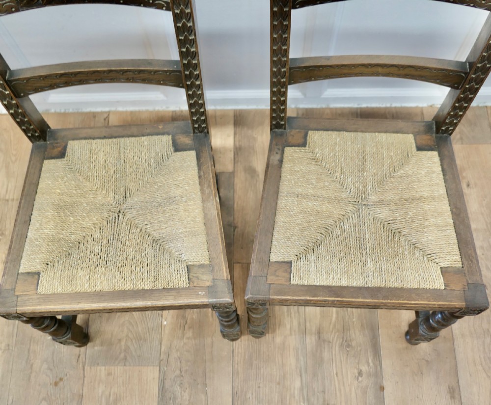 A Pair of Arts and Crafts Gothic Carved Oak Hall Chairs View V
