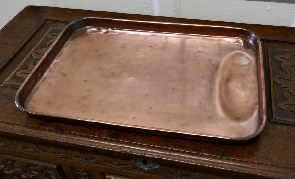 A large rectangular copper roasting tray featuring rolled rims and an indented oval gravy well at one end. View II