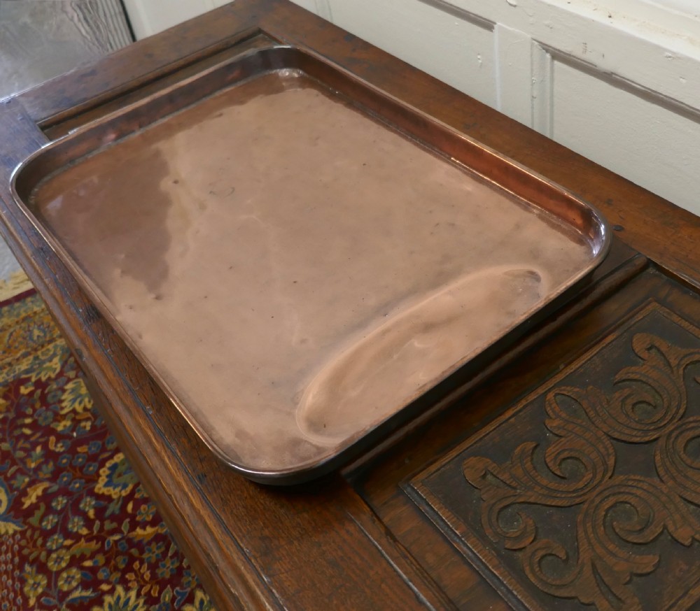 A large rectangular copper roasting tray featuring rolled rims and an indented oval gravy well at one end. View III