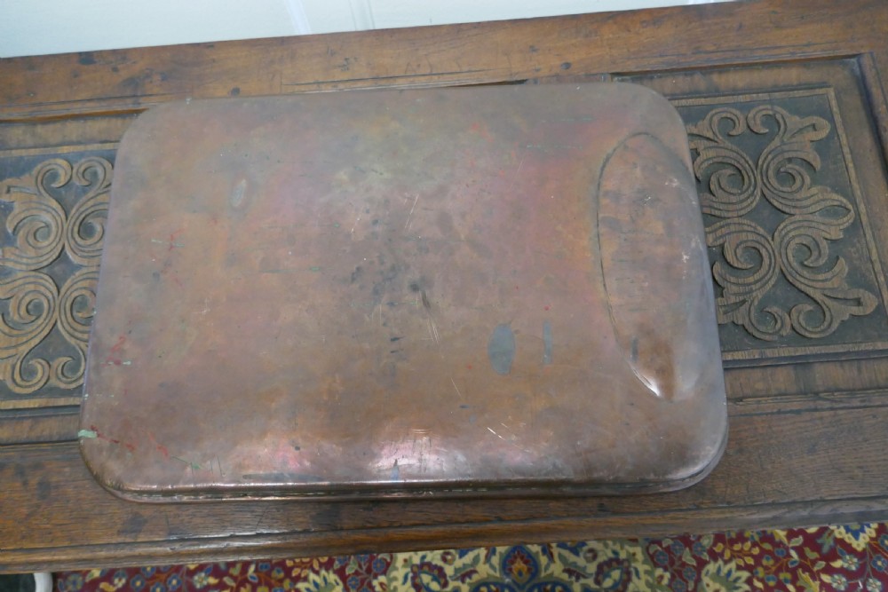 A large rectangular copper roasting tray featuring rolled rims and an indented oval gravy well at one end. View VI