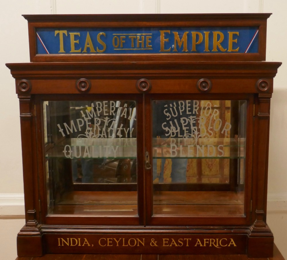A Victorian mahogany shop counter display cabinet with etched glass doors, mirror backing, and gold lettering reading Teas of the Empire.
