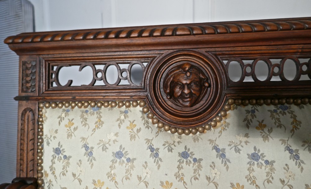 A pair of carved dark wood French Gothic armchair thrones with floral upholstered backrests and seats. View VII
