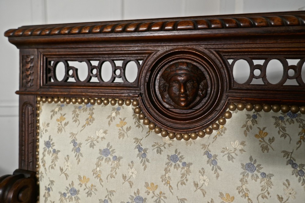 A pair of carved dark wood French Gothic armchair thrones with floral upholstered backrests and seats. View VIII