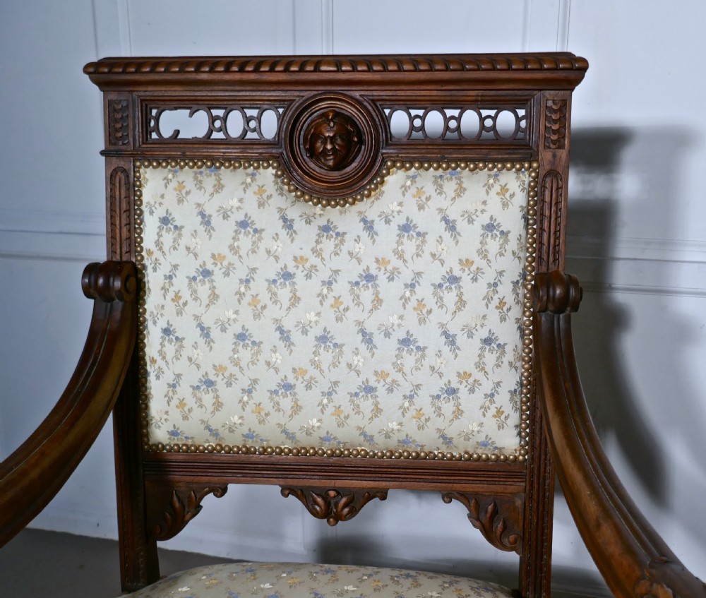 A pair of carved dark wood French Gothic armchair thrones with floral upholstered backrests and seats. View IX