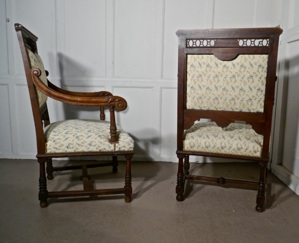 A pair of carved dark wood French Gothic armchair thrones with floral upholstered backrests and seats. View XI