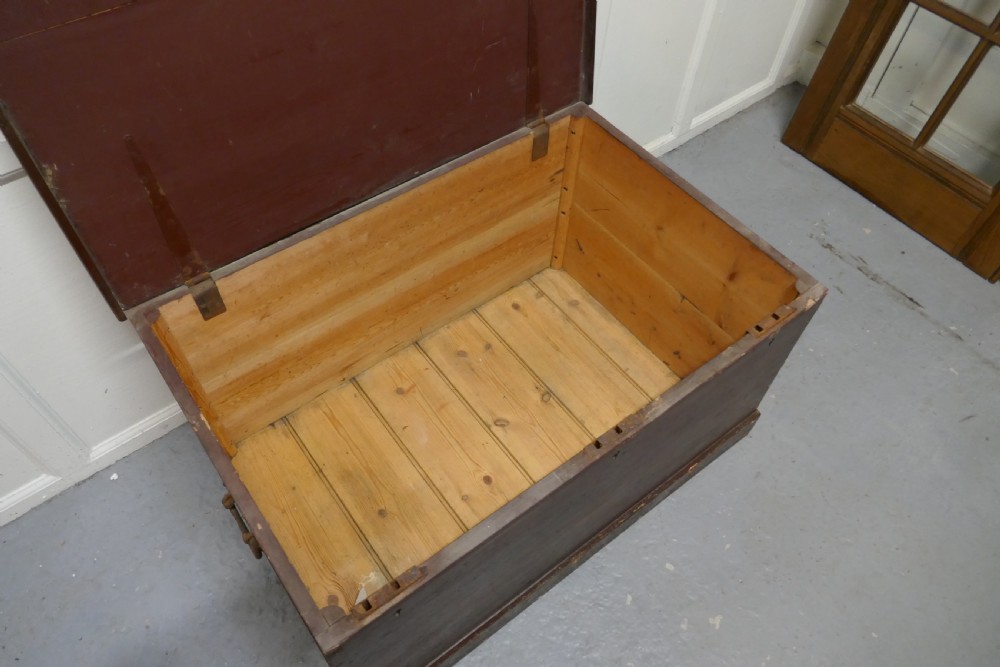A 19th-century dark stained pine lodge chest featuring white painted lettering on the hinged top lid and a solid plinth base. View VI