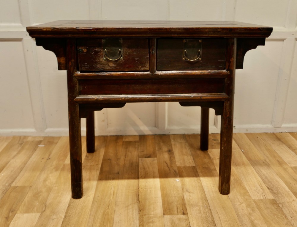 A dark brown lacquered wooden Chinese side table featuring two drawers with brass handles and straight legs.