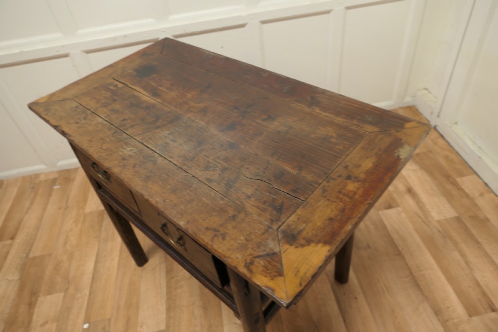 A dark brown lacquered wooden Chinese side table featuring two drawers with brass handles and straight legs. View VII