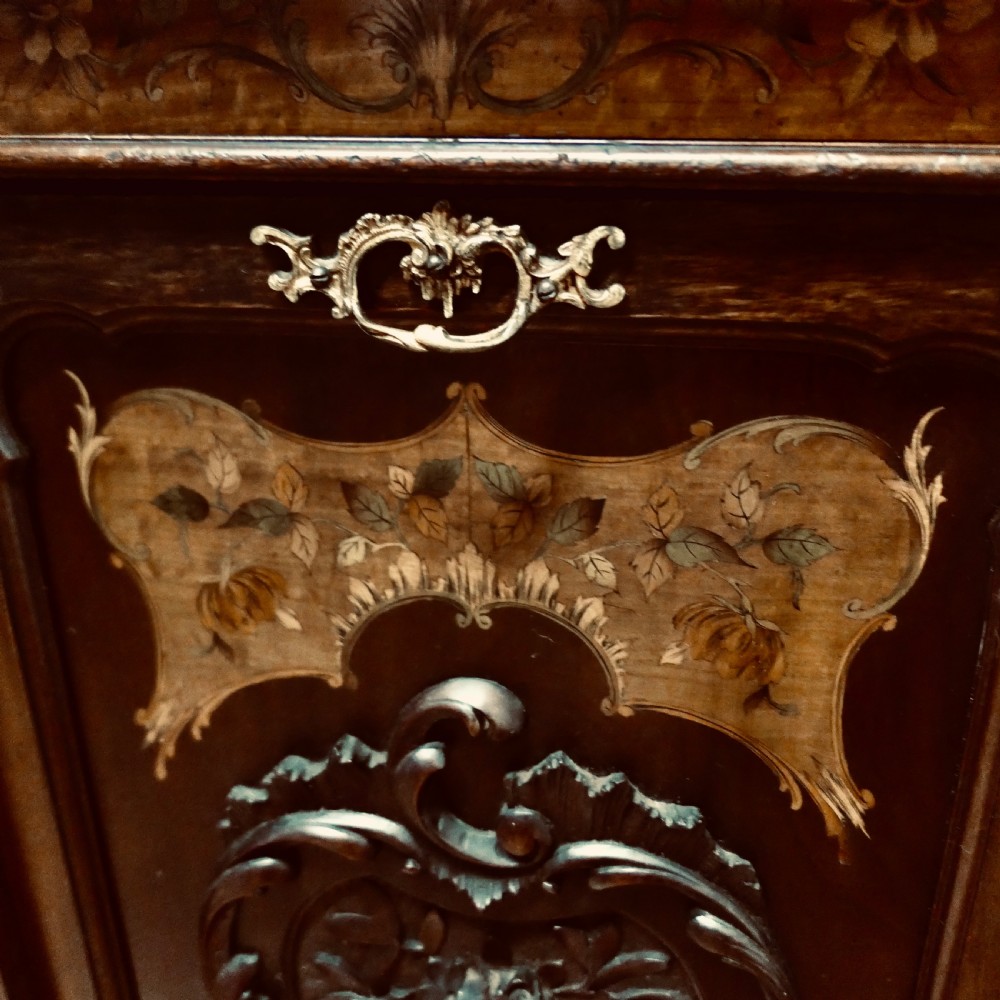A late nineteenth-century dark wood coal purdonium featuring decorative floral marquetry inlay, carved scroll cresting, and a brass drop handle. View VIII