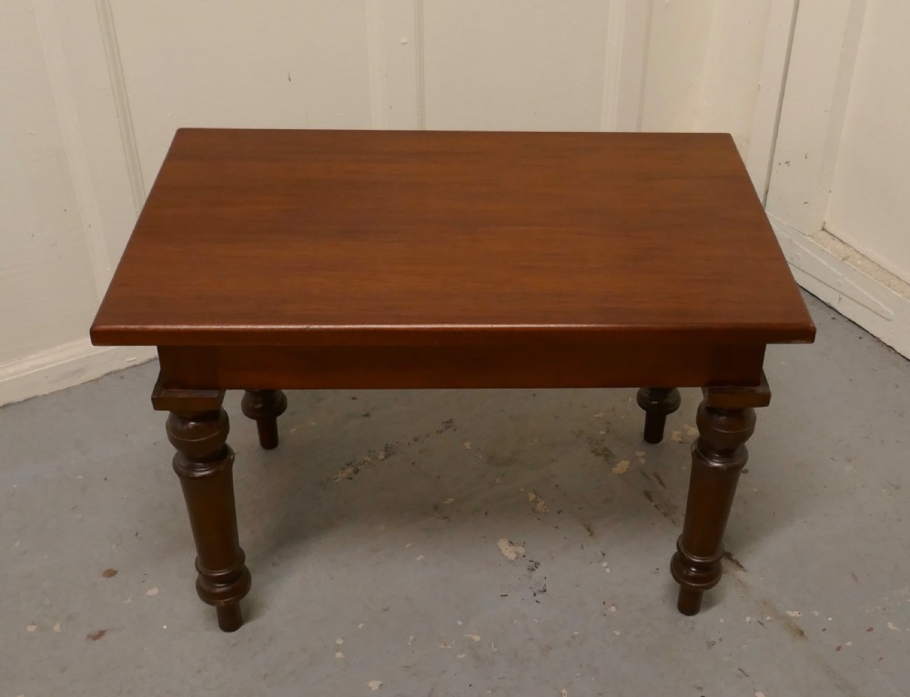 A rectangular Victorian mahogany occasional table with turned legs and a warm brown polish. View II