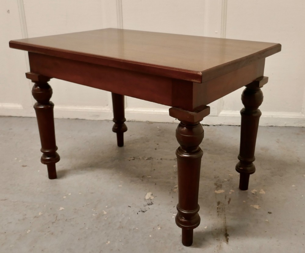 A rectangular Victorian mahogany occasional table with turned legs and a warm brown polish. View VI