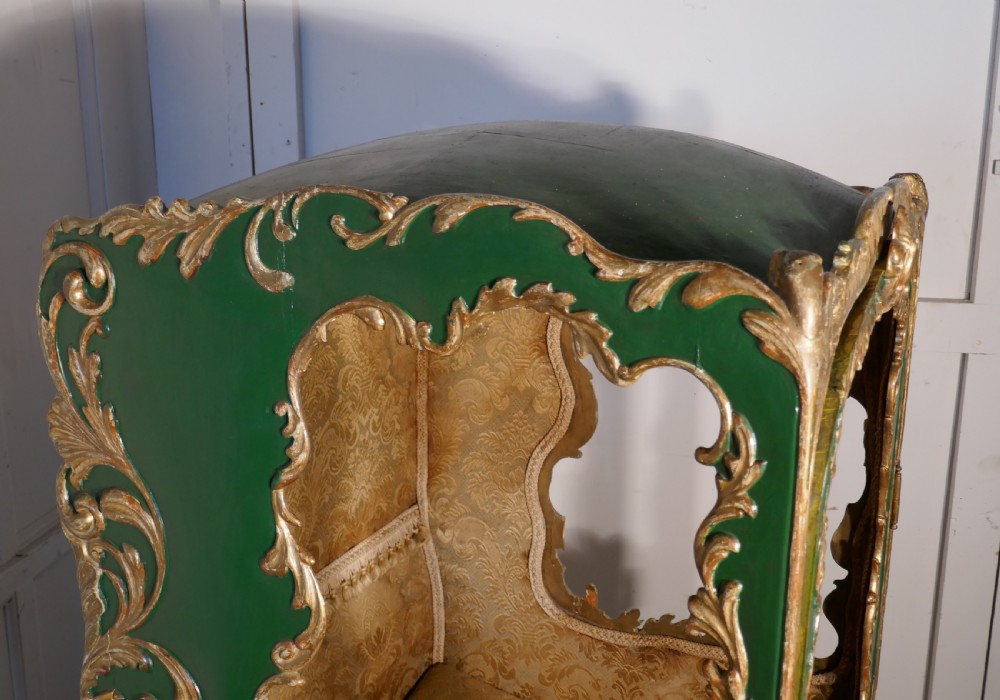 A 19th-century green painted and giltwood Italian sedan chair featuring hand-carved scrollwork, window openings, gold fabric lining, and wooden carrying poles. View IX