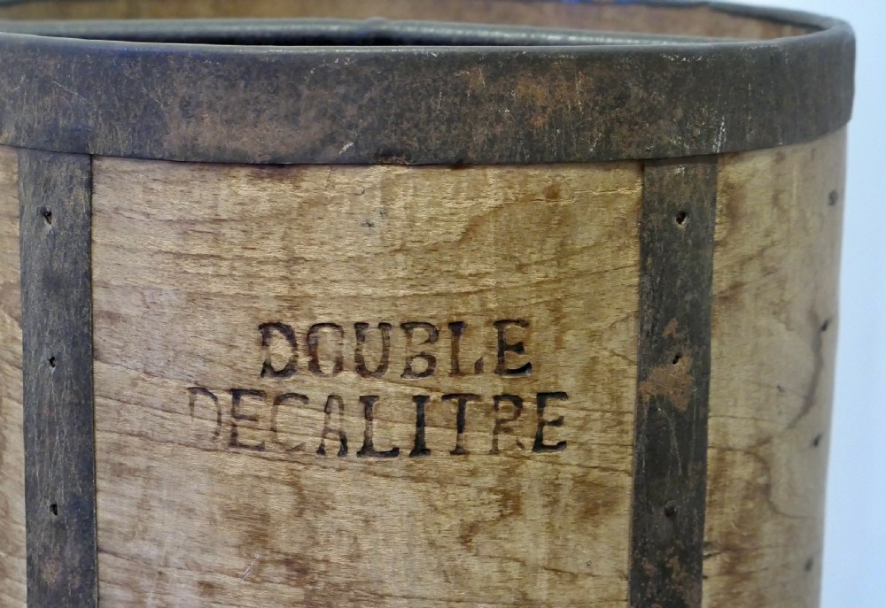 A cylindrical 19th-century French wooden grain measure reinforced with metal bands and stamped with the words DOUBLE DECALITRE. View II