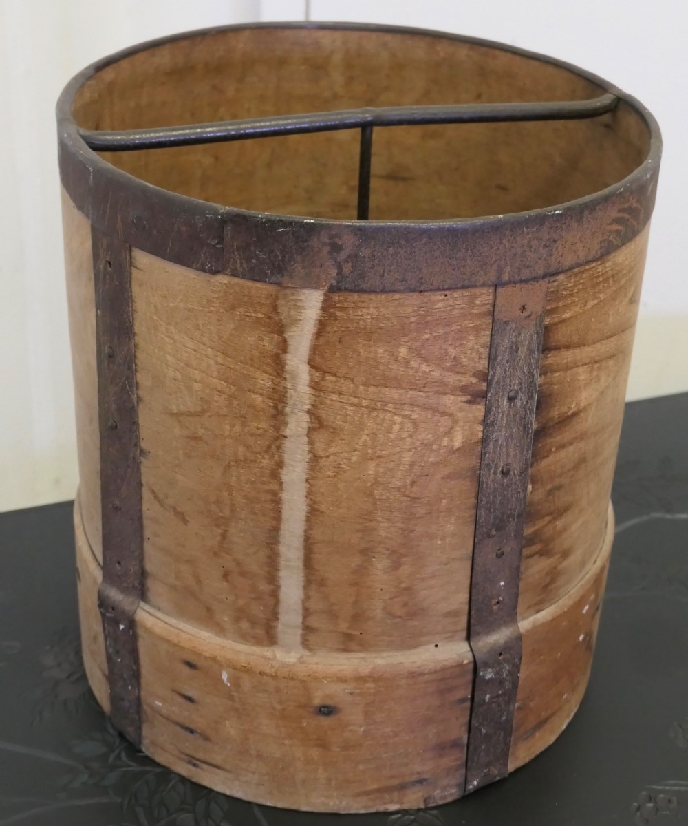 A cylindrical 19th-century French wooden grain measure reinforced with metal bands and stamped with the words DOUBLE DECALITRE. View IV