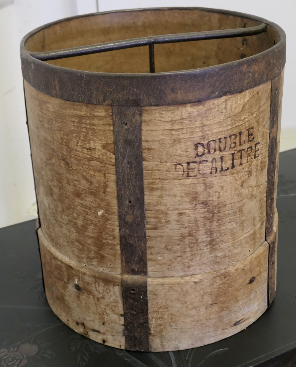A cylindrical 19th-century French wooden grain measure reinforced with metal bands and stamped with the words DOUBLE DECALITRE. View VII