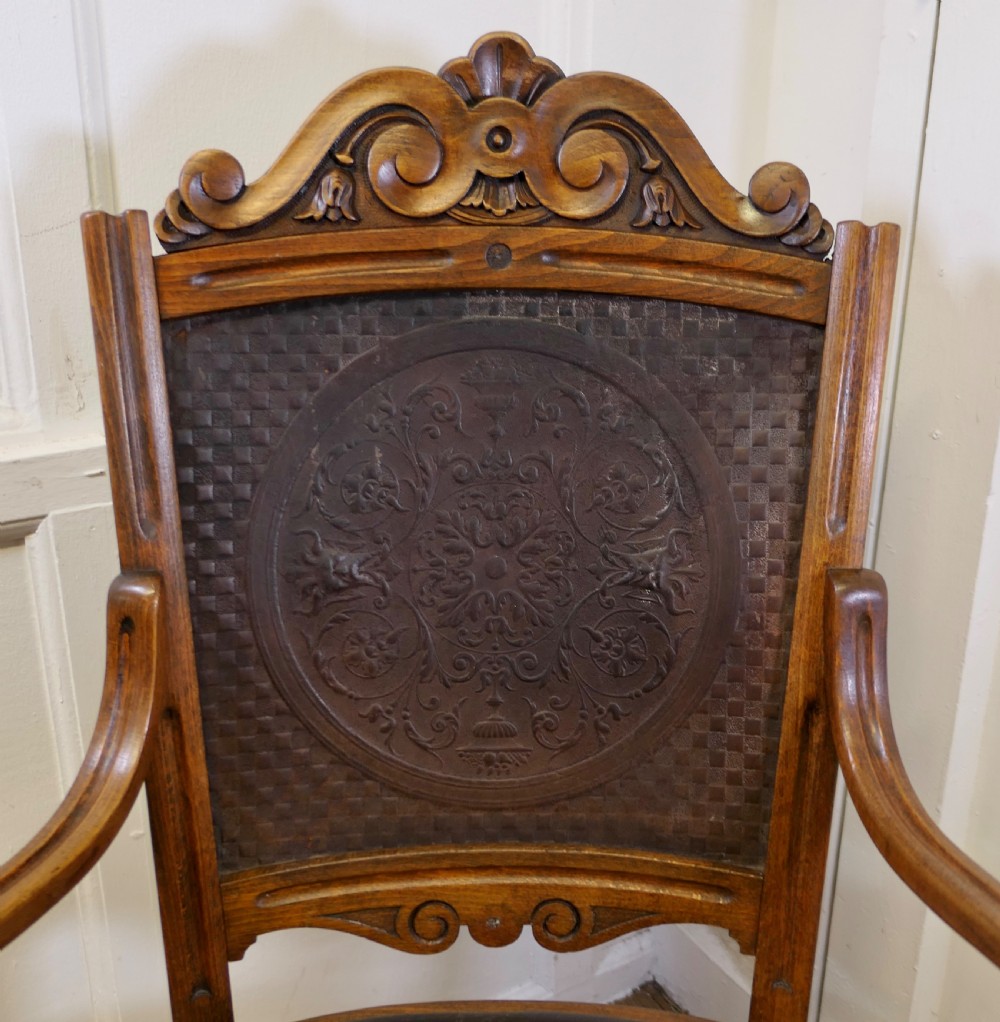 A Victorian bentwood armchair featuring a dark brown leather seat, scrolled armrests, turned front legs, and an embossed patterned back panel. View III