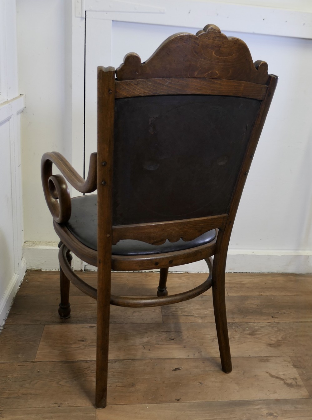 A Victorian bentwood armchair featuring a dark brown leather seat, scrolled armrests, turned front legs, and an embossed patterned back panel. View VIII