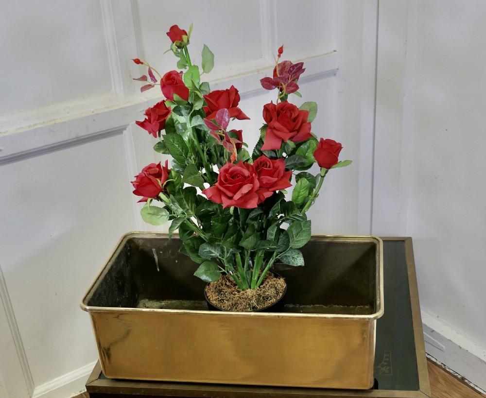 A heavy rectangular solid brass planter trough with rounded corners and a folded top rim. View II