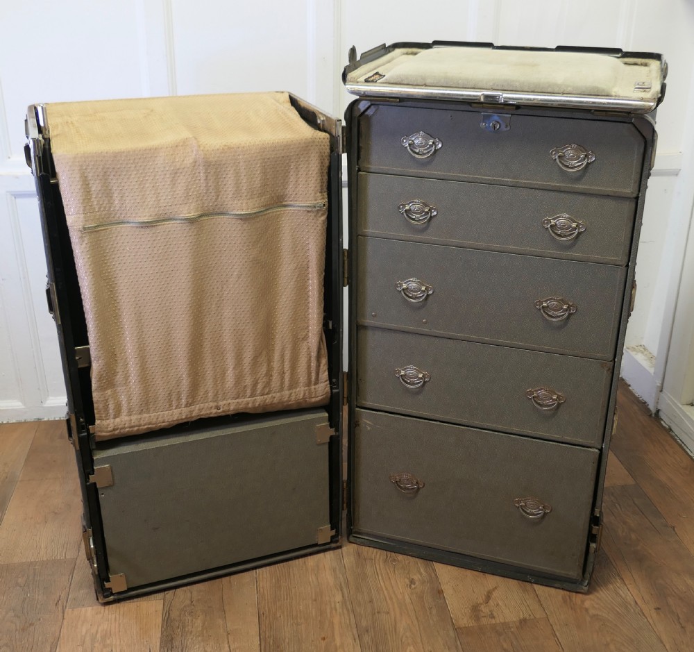 An open Art Deco Hartmann fitted steamer trunk featuring a section with wooden clothes hangers and a section with five pull-out drawers. View II