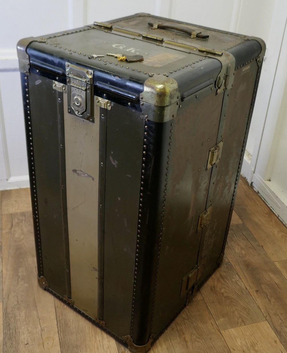 An open Art Deco Hartmann fitted steamer trunk featuring a section with wooden clothes hangers and a section with five pull-out drawers. View III