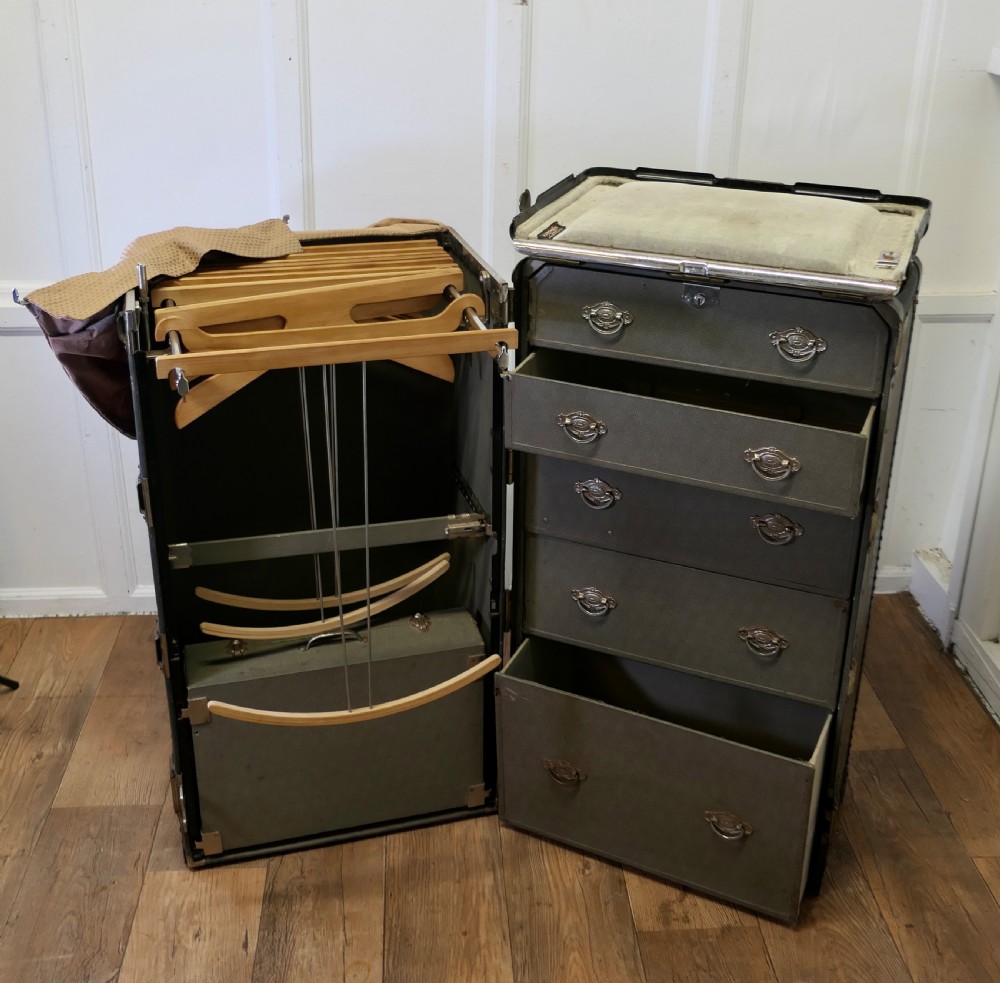 An open Art Deco Hartmann fitted steamer trunk featuring a section with wooden clothes hangers and a section with five pull-out drawers. View IX
