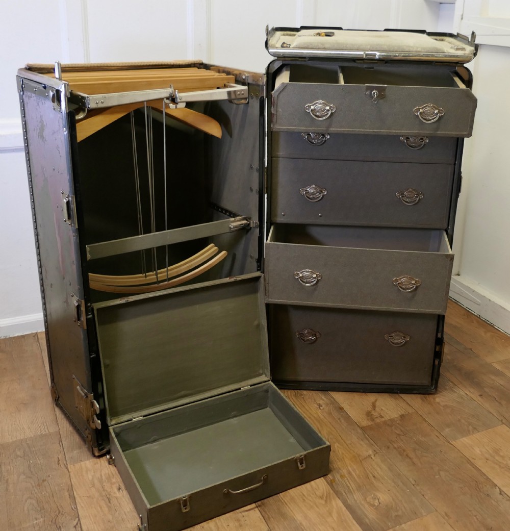 An open Art Deco Hartmann fitted steamer trunk featuring a section with wooden clothes hangers and a section with five pull-out drawers. View XII