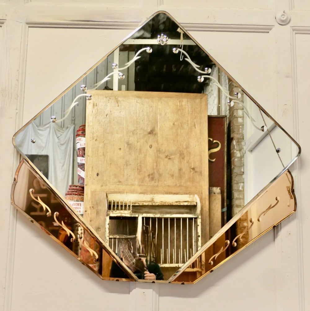 A diamond-shaped Art Deco wall mirror featuring a clear main glass panel with etched scroll motifs and angled peach-tinted glass lower borders. View III