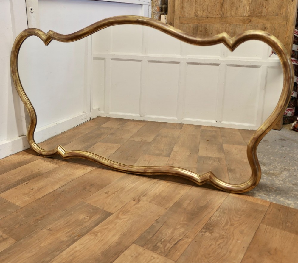 A Superb Very Large Italian Gilt Scallop Shaped Mirror