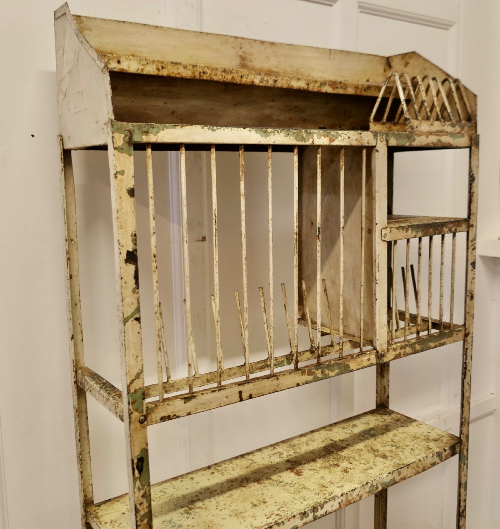 A tall distressed cream metal French field kitchen dresser with an upper plate rack, open shelving, and a perforated double-door lower cabinet. View III