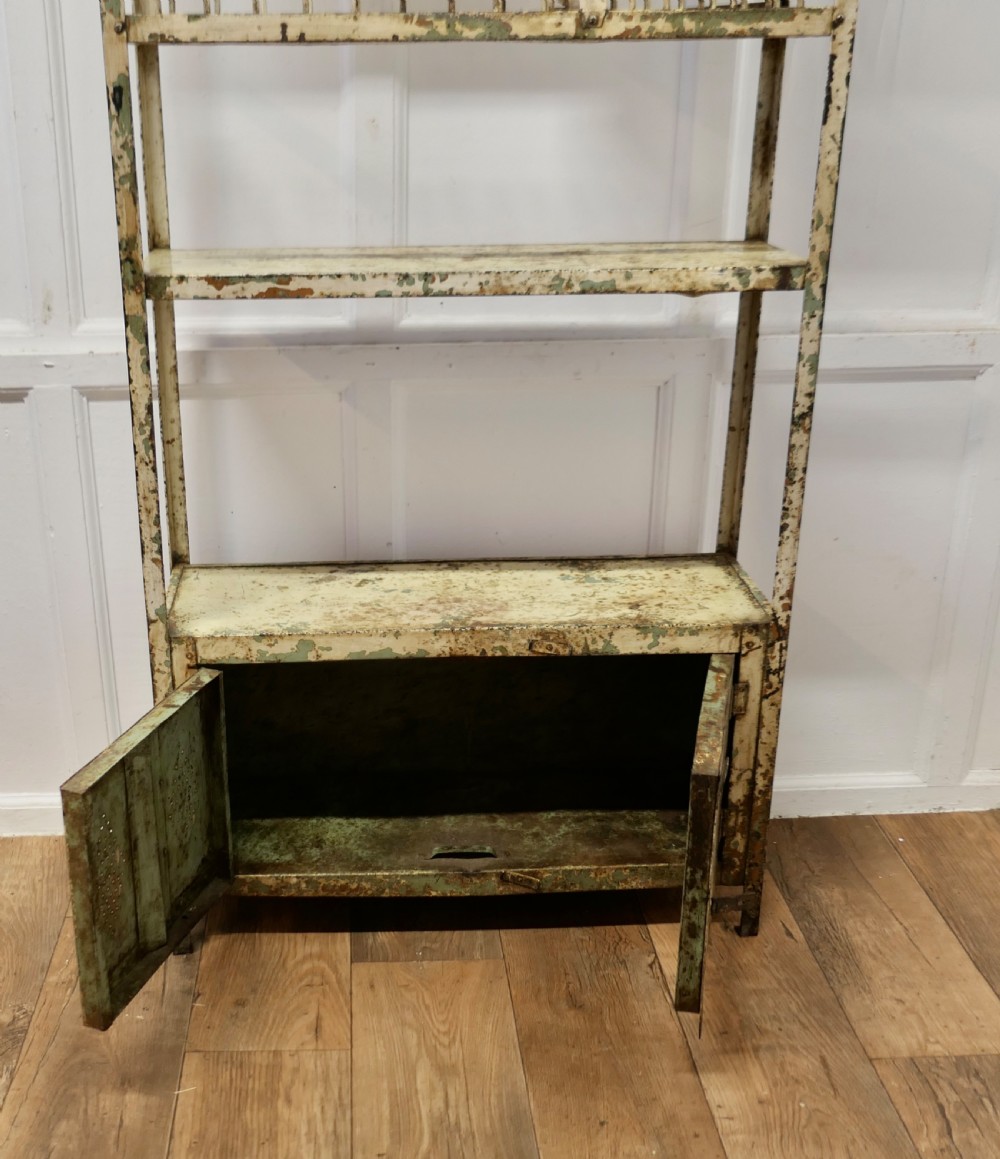 A tall distressed cream metal French field kitchen dresser with an upper plate rack, open shelving, and a perforated double-door lower cabinet. View VI