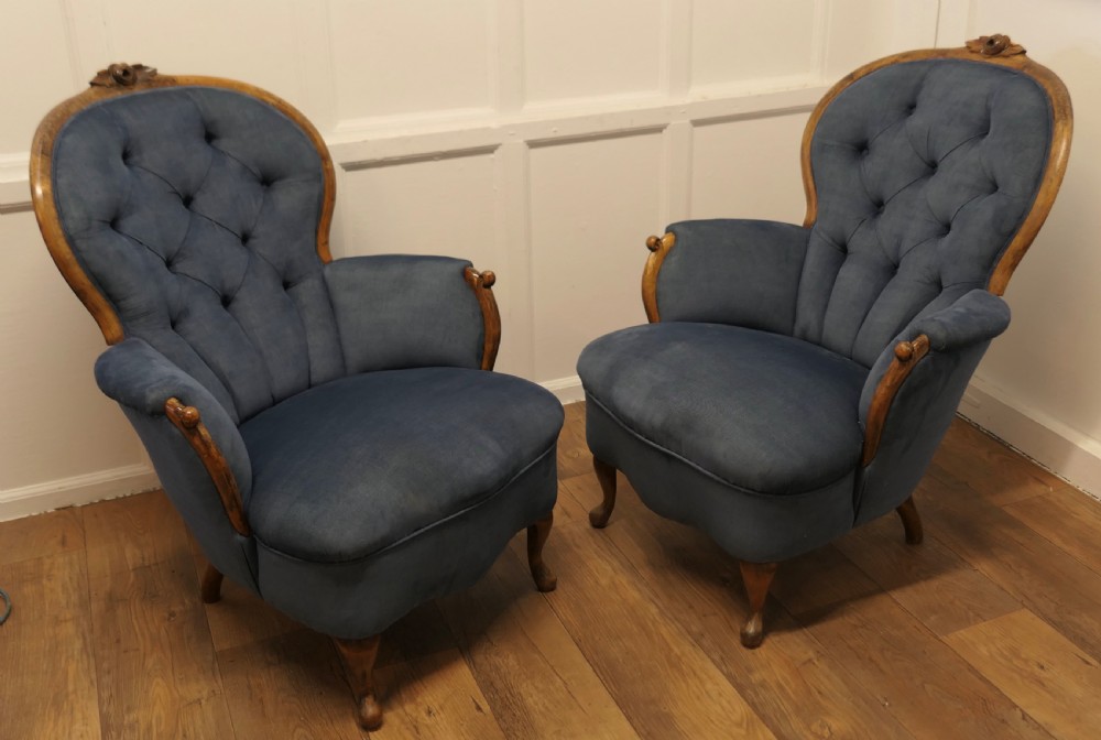 A pair of French salon armchairs upholstered in blue button-backed velvet with carved walnut frames and short wooden legs. View III