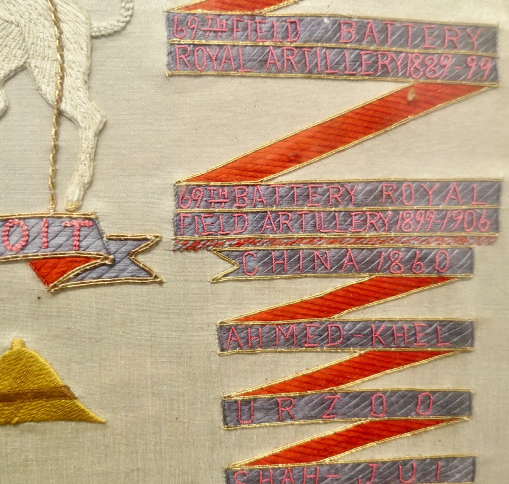 A framed Victorian military silk embroidery panel featuring the Royal Field Artillery coat of arms with lions, unicorns, cannons, and regimental banners within a glazed gilt frame. View V