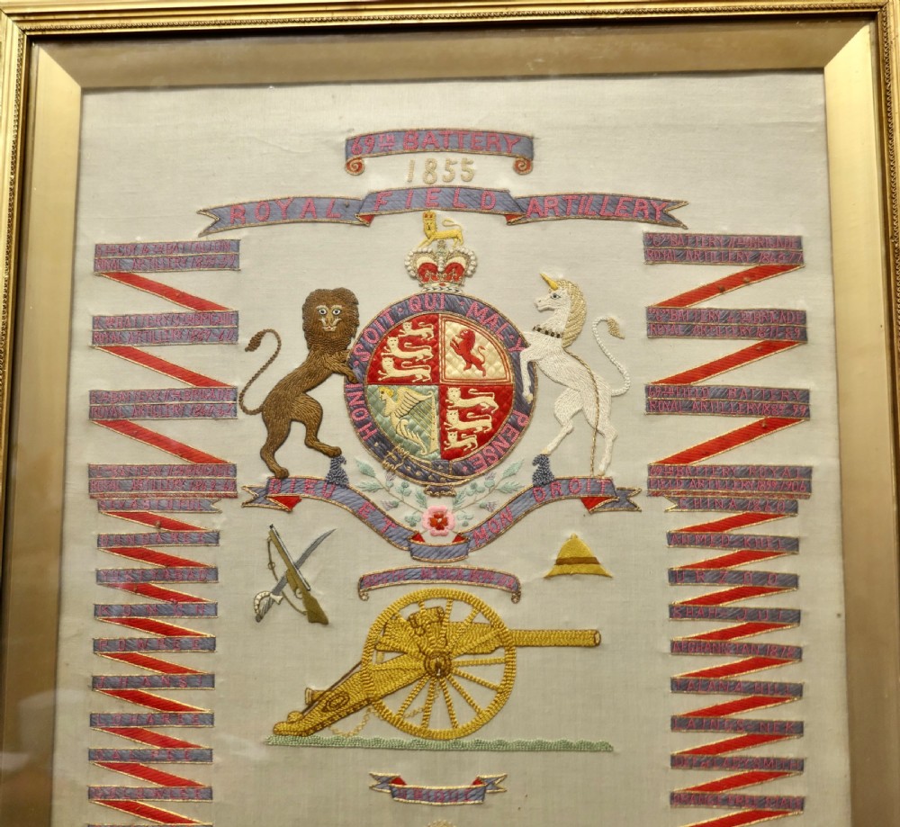 A framed Victorian military silk embroidery panel featuring the Royal Field Artillery coat of arms with lions, unicorns, cannons, and regimental banners within a glazed gilt frame. View VI